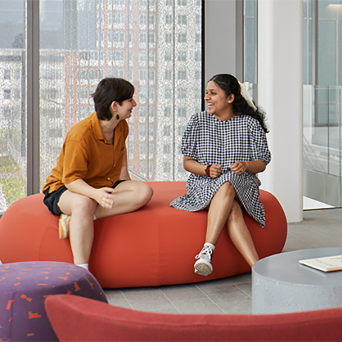 Students talking in a lobby. Links to Gifts of Appreciated Securities securities.jpg